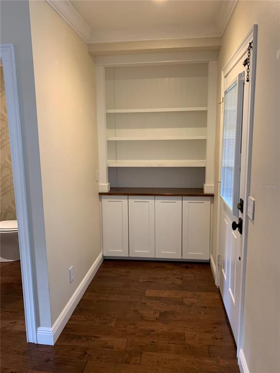 910 Pawstand Road Celebration, FL 34747 - Photo 15 of 33 a view of a room with wooden floor and staircase
