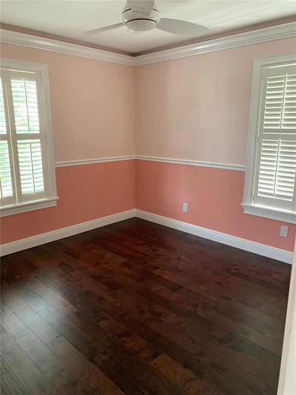 910 Pawstand Road Celebration, FL 34747 - Photo 17 of 33 an empty room with wooden floor and windows
