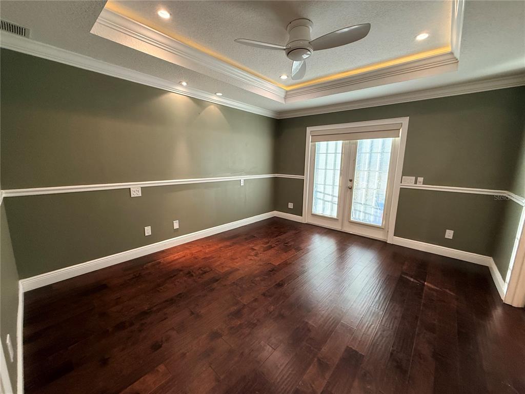 910 Pawstand Road Celebration, FL 34747 - Photo 19 of 33 an empty room with wooden floor and windows
