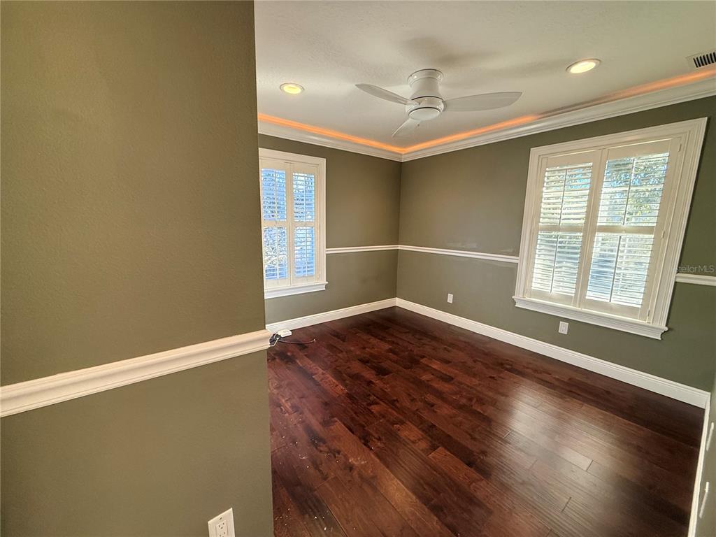 910 Pawstand Road Celebration, FL 34747 - Photo 20 of 33 an empty room with wooden floor and windows