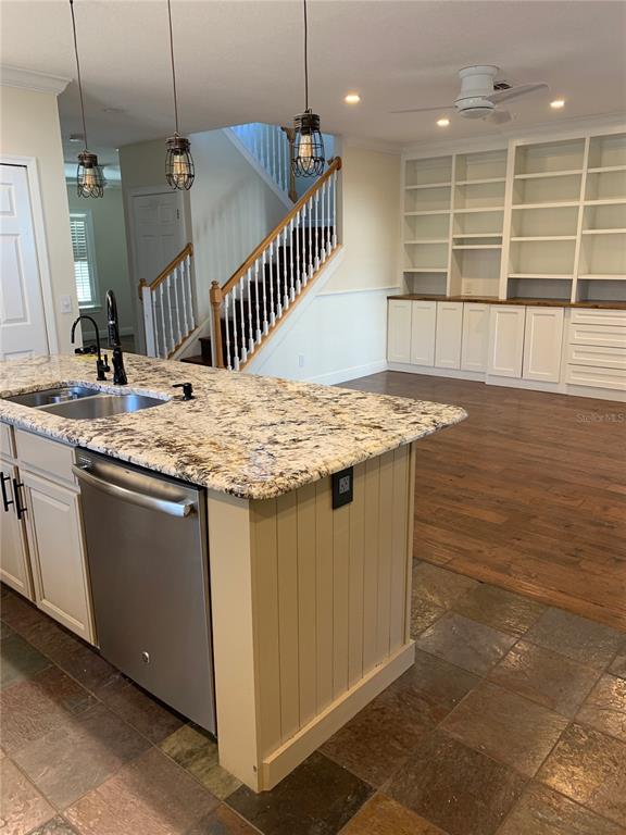 910 Pawstand Road Celebration, FL 34747 - Photo 26 of 33 a kitchen with a sink a counter top space and cabinets