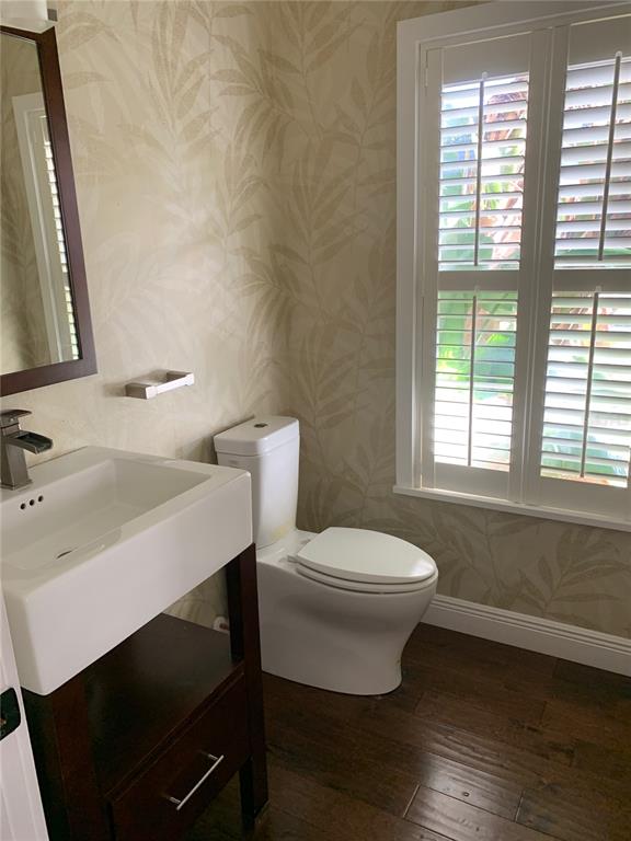910 Pawstand Road Celebration, FL 34747 - Photo 28 of 33 a bathroom with a sink a toilet a window and mirror