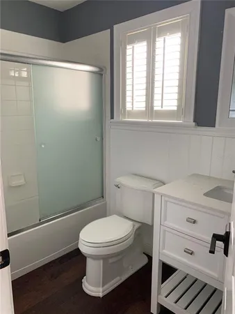 a bathroom with a toilet and a shower
