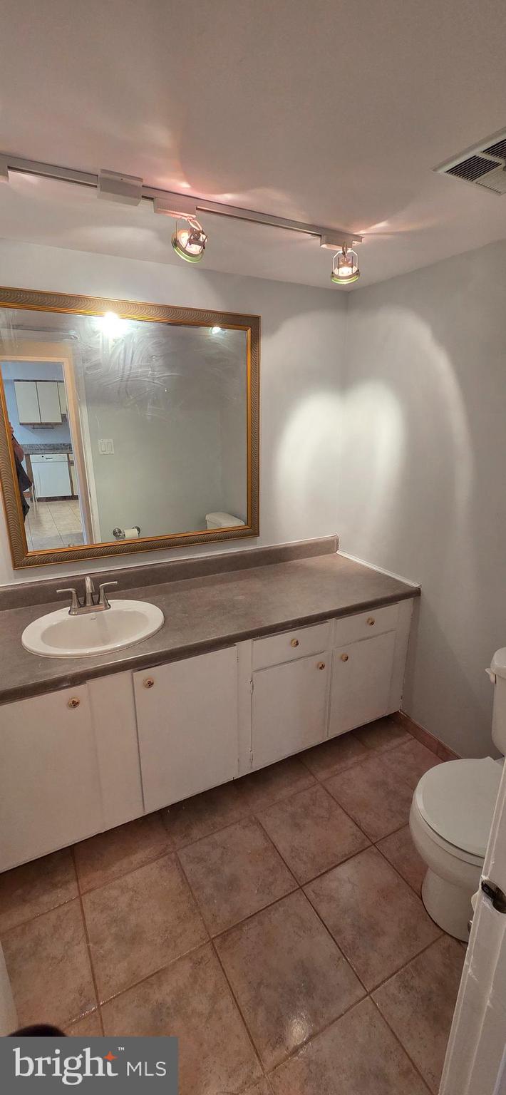 11764 Indian Ridge Road Reston, VA 20191 - Photo 12 of 31 a bathroom with a sink a toilet and a mirror