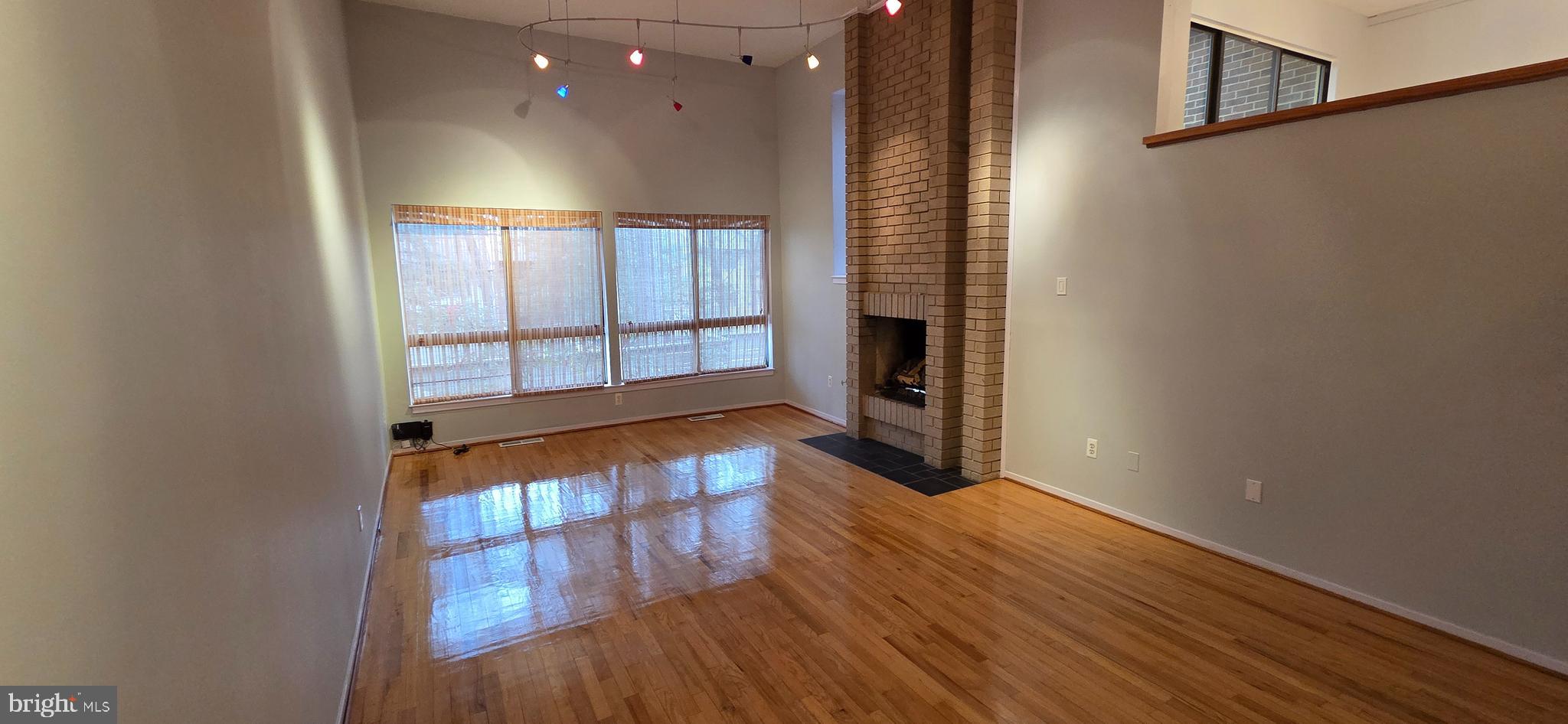 11764 Indian Ridge Road Reston, VA 20191 - Photo 14 of 31 wooden floor in an empty room with a window