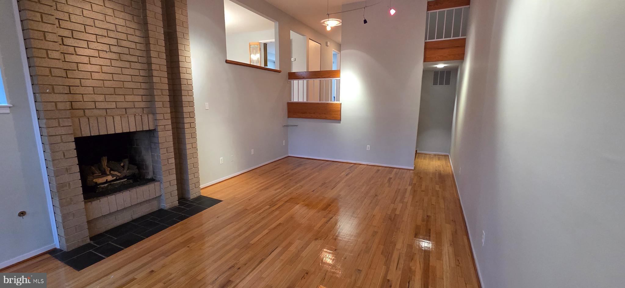 11764 Indian Ridge Road Reston, VA 20191 - Photo 15 of 31 a view of a livingroom with wooden floor and a fireplace