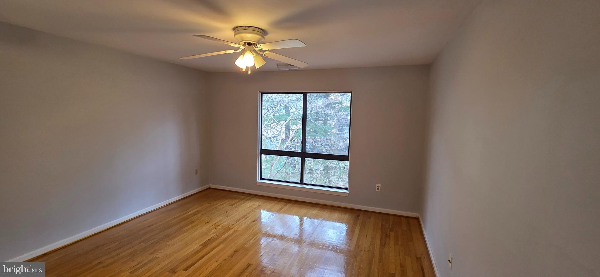 11764 Indian Ridge Road Reston, VA 20191 - Photo 16 of 31 an empty room with windows and chandelier fan