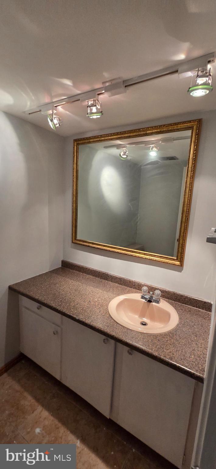 11764 Indian Ridge Road Reston, VA 20191 - Photo 18 of 31 a bathroom with a sink a vanity and a mirror