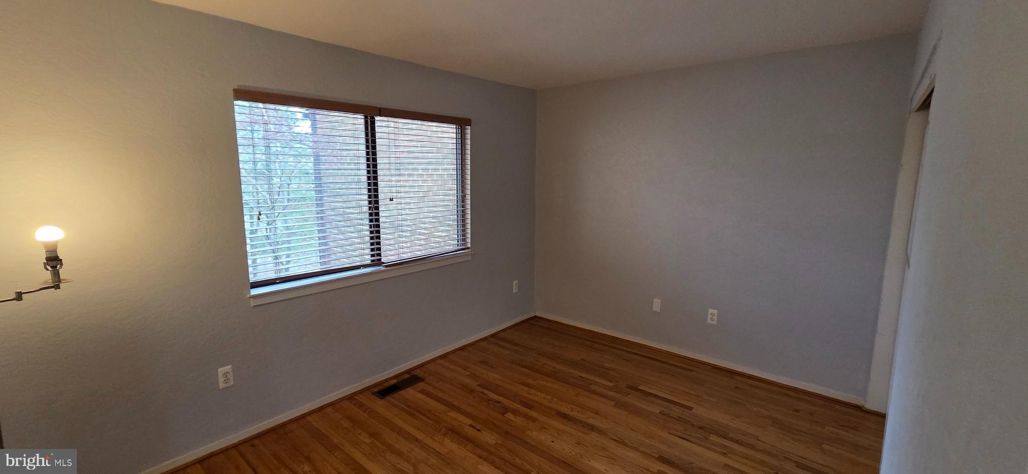 11764 Indian Ridge Road Reston, VA 20191 - Photo 20 of 31 an empty room with wooden floor and windows