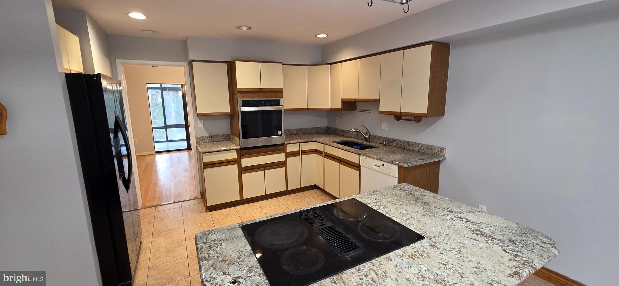 11764 Indian Ridge Road Reston, VA 20191 - Photo 2 of 31 a kitchen with granite countertop a refrigerator stove and sink