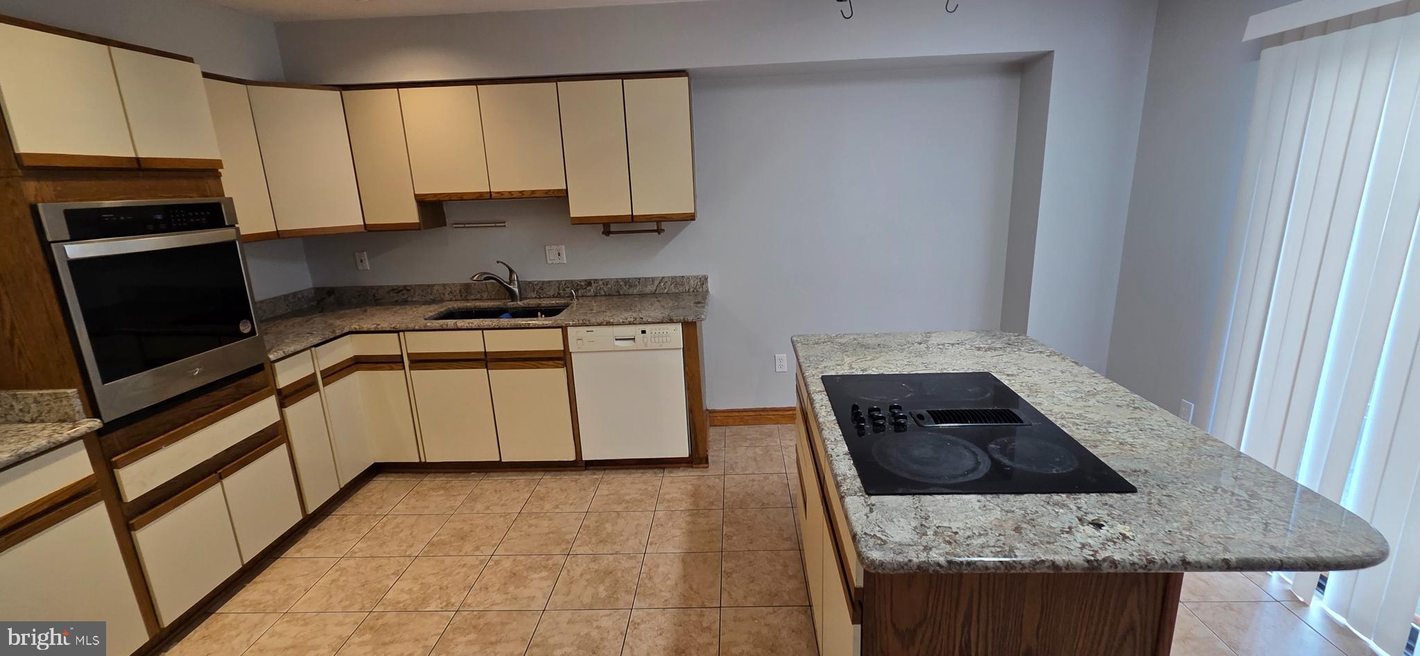 11764 Indian Ridge Road Reston, VA 20191 - Photo 4 of 31 a kitchen with stainless steel appliances granite countertop a stove a sink and a microwave