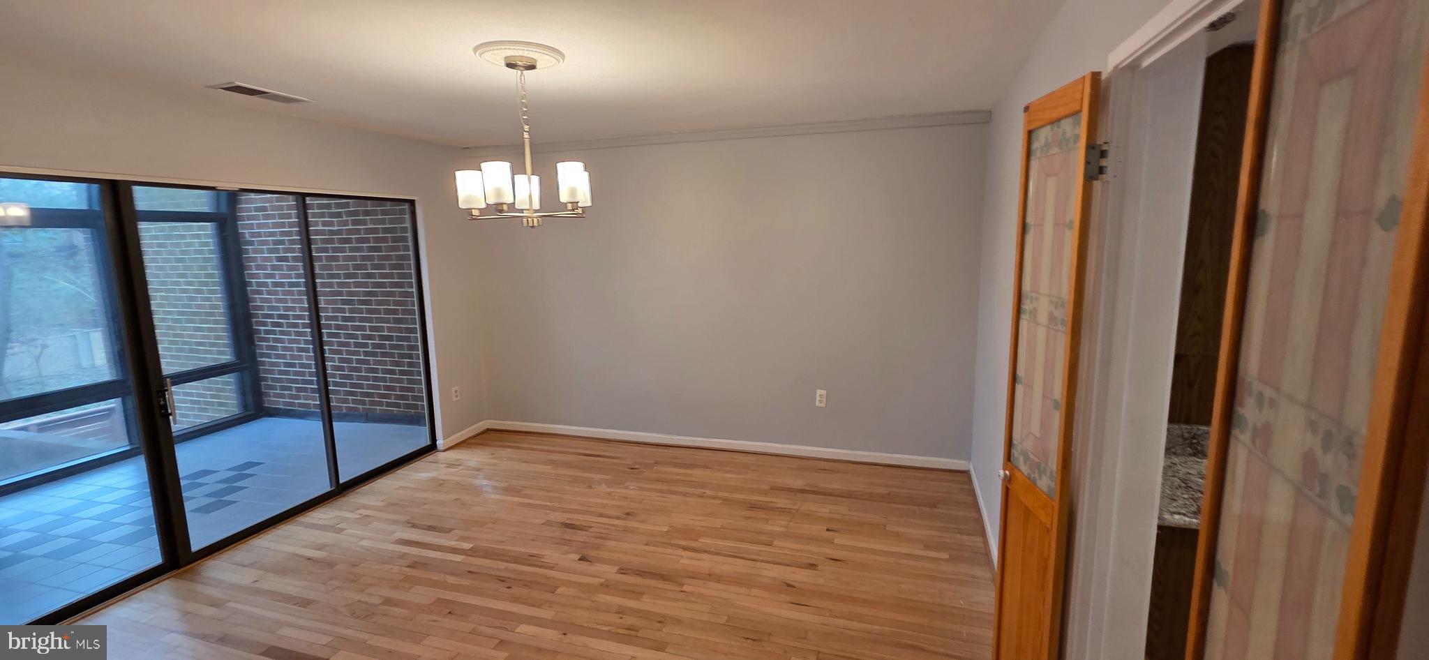 11764 Indian Ridge Road Reston, VA 20191 - Photo 9 of 31 wooden floor in an empty room with a window