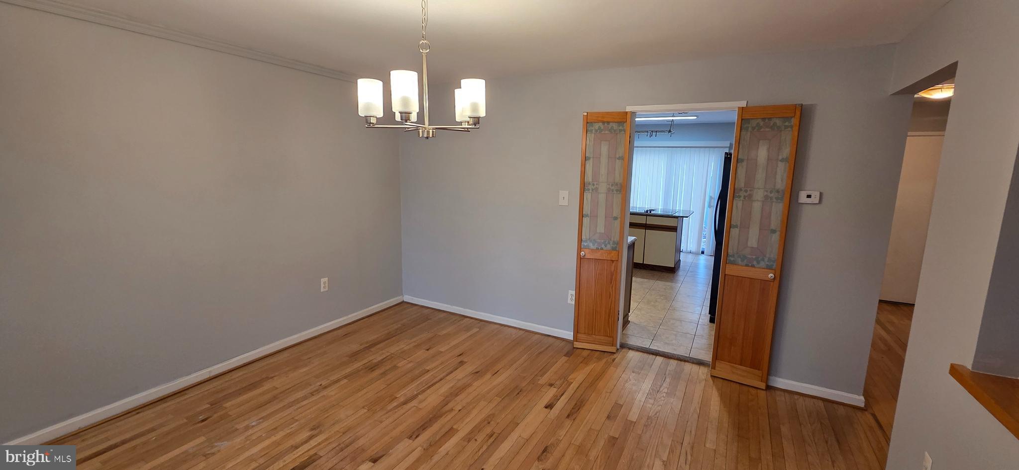 11764 Indian Ridge Road Reston, VA 20191 - Photo 10 of 31 wooden floor in an empty room with a mirror