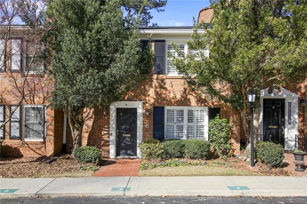 4620 Wieuca Road Northeast, Unit 9 Atlanta, GA 30342 - Photo 1 of 1 a front view of a house with yard tree and glass windows