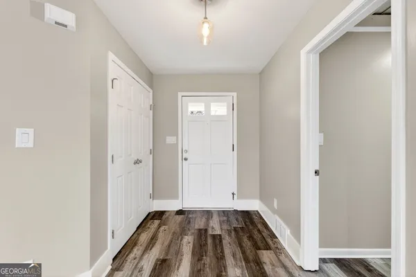 a view of a livingroom with wooden floor and staircase