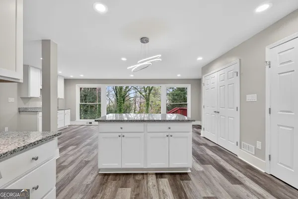 a view of a kitchen with granite countertop cabinets and a sink