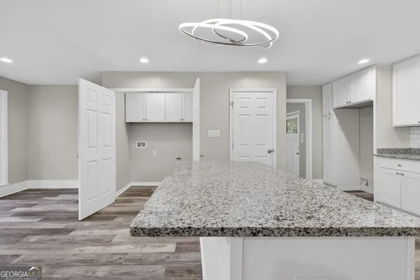 a view of kitchen island a sink and dishwasher
