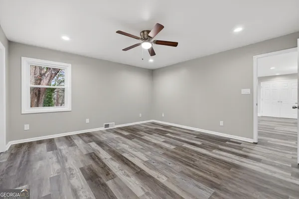 wooden floor in an empty room with a window