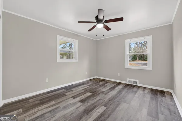 a view of room with hardwood floor and window