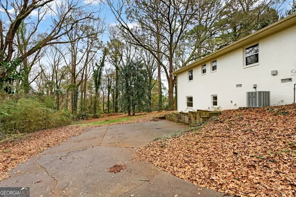 a view of a white house with a snow on the road
