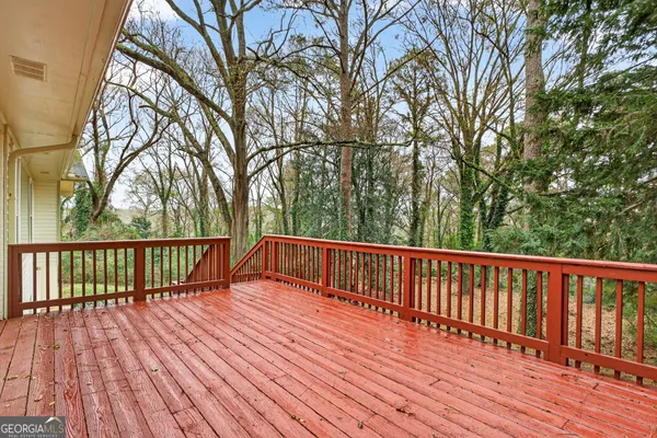 a view of balcony with wooden floor and fence