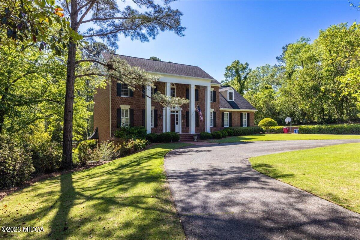 1158 St Andrews Drive Macon, GA 31210 - Photo 1 of 79 a front view of house with yard and swimming pool