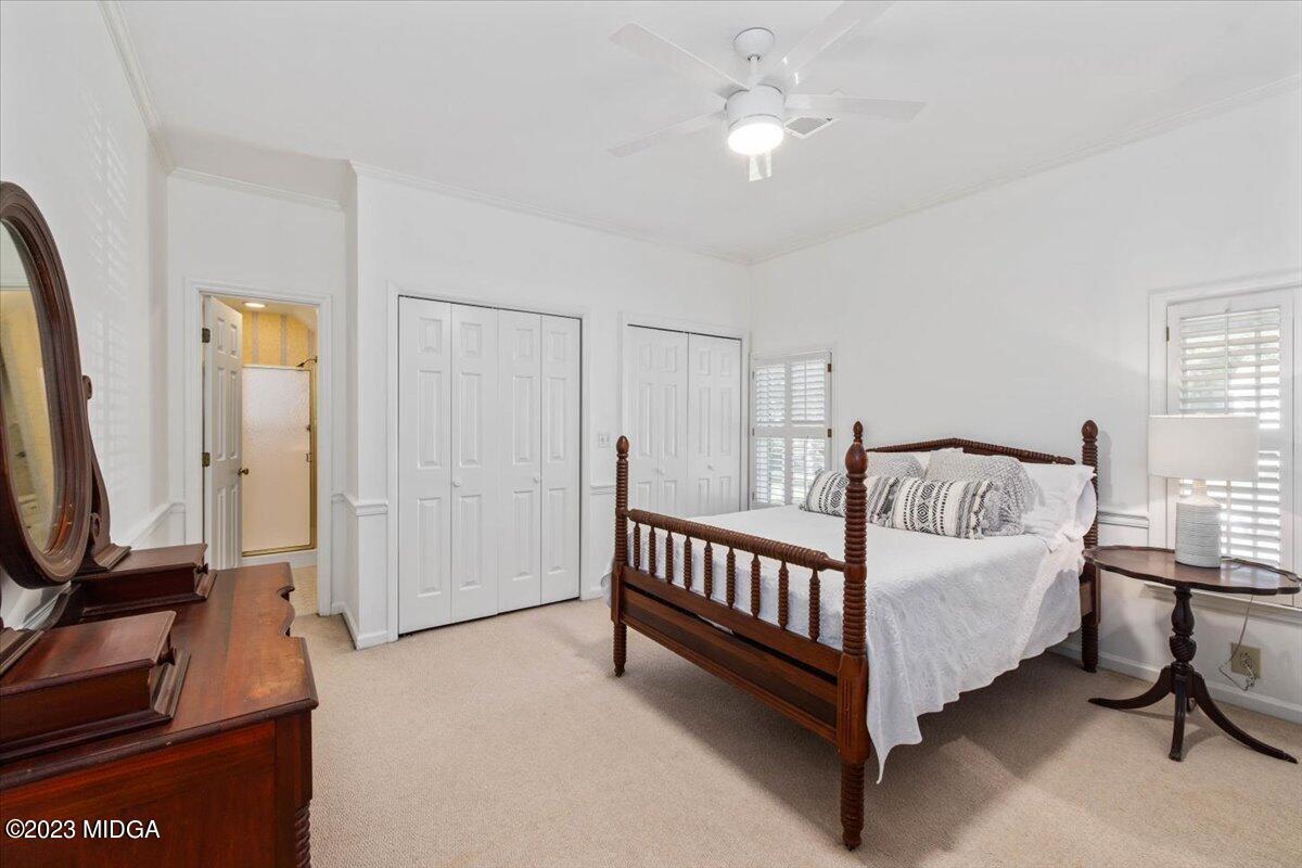 1158 St Andrews Drive Macon, GA 31210 - Photo 12 of 79 a bedroom with a bed and a flat tv screen on the dresser