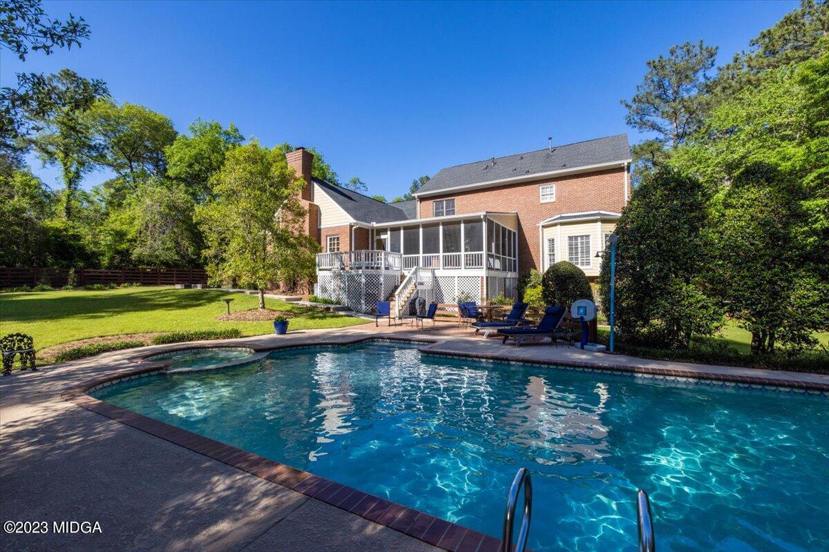 1158 St Andrews Drive Macon, GA 31210 - Photo 17 of 79 a view of swimming pool with lawn chairs and plants