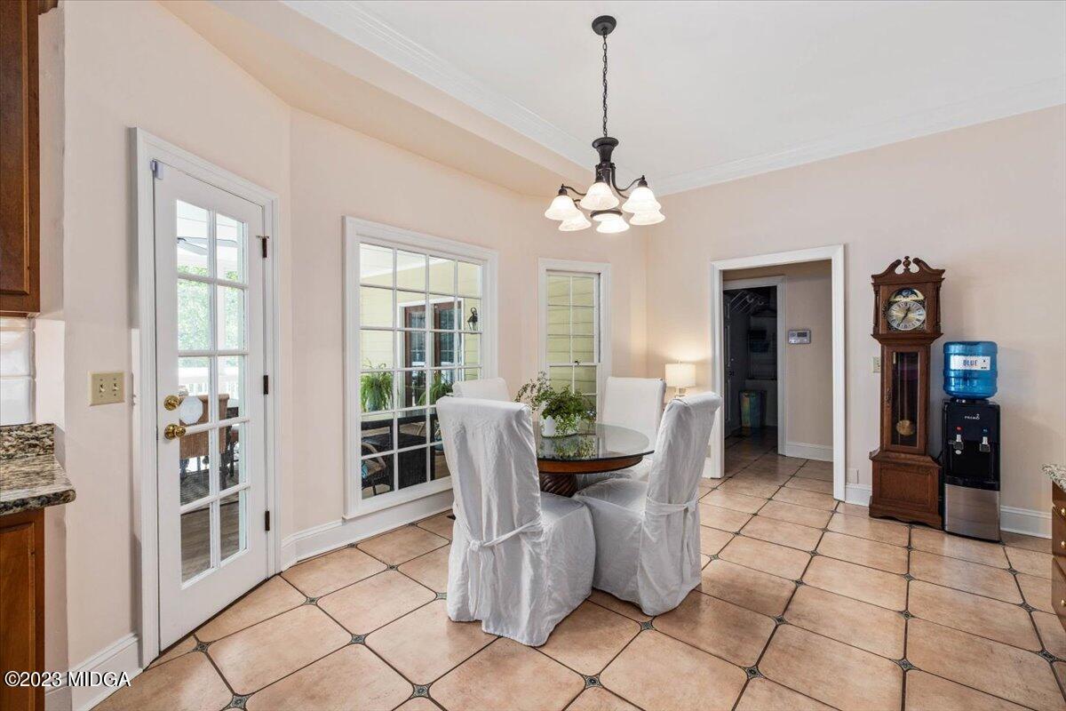 1158 St Andrews Drive Macon, GA 31210 - Photo 19 of 79 a view of a dining room with furniture and chandelier