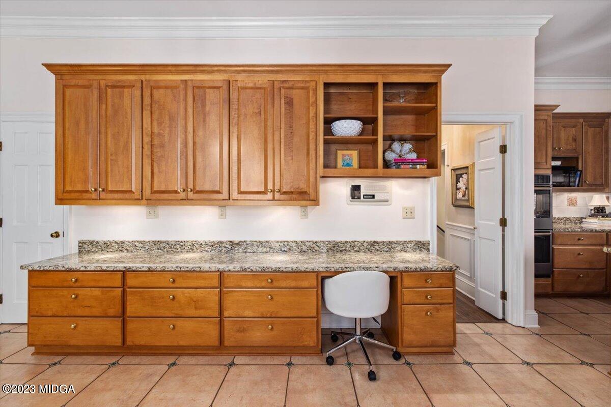 1158 St Andrews Drive Macon, GA 31210 - Photo 27 of 79 a kitchen with granite countertop cabinets a sink appliances and a counter top space