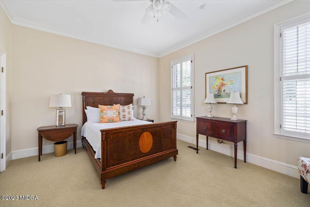 1158 St Andrews Drive Macon, GA 31210 - Photo 28 of 79 a spacious bedroom with a bed and a table in it
