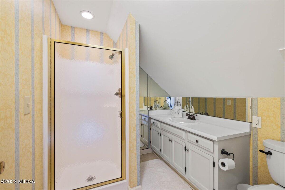 1158 St Andrews Drive Macon, GA 31210 - Photo 40 of 79 a bathroom with a double vanity sink mirror and shower