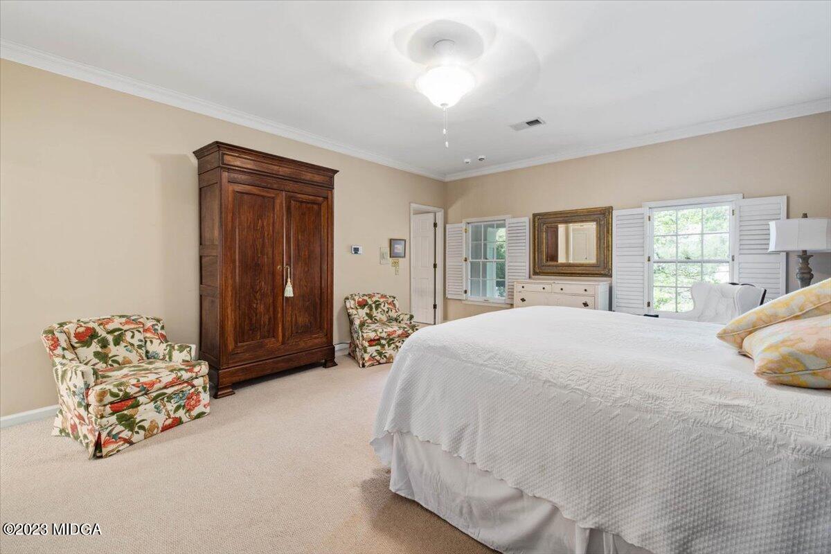 1158 St Andrews Drive Macon, GA 31210 - Photo 43 of 79 a spacious bedroom with a bed and a large mirror with window