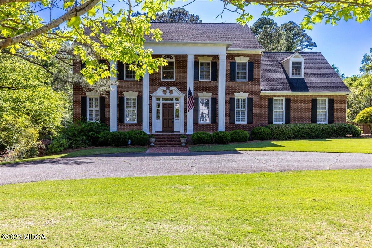 1158 St Andrews Drive Macon, GA 31210 - Photo 5 of 79 a view of a brick house with a swimming pool