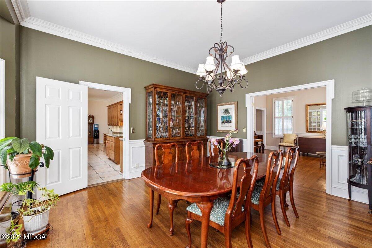 1158 St Andrews Drive Macon, GA 31210 - Photo 60 of 79 a dining room with furniture a chandelier and wooden floor