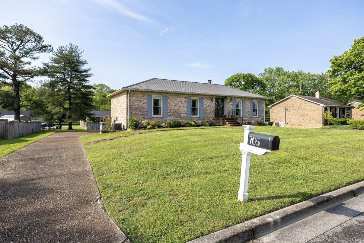 a front view of house with yard and green space