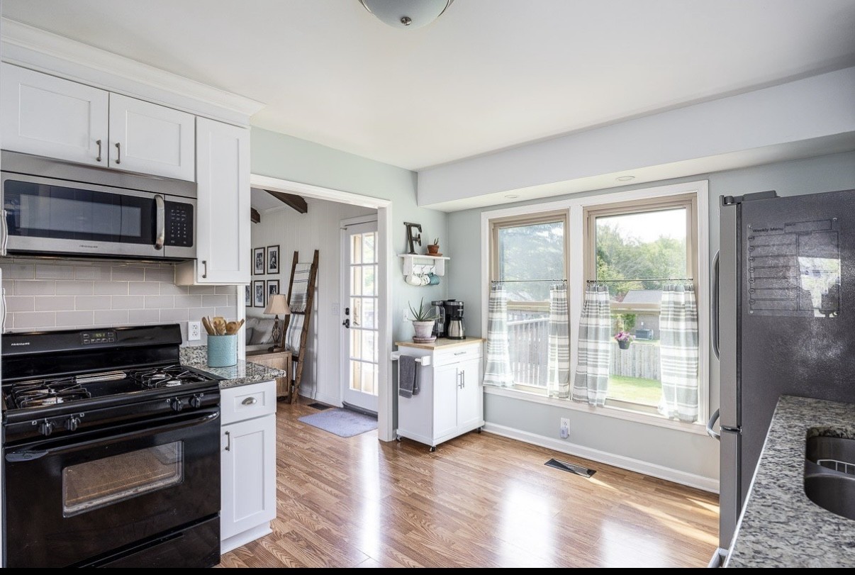 705 Baugh Road Nashville, TN 37221 - Photo 11 of 31 a kitchen with wooden floors and appliances