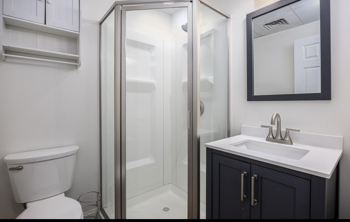 705 Baugh Road Nashville, TN 37221 - Photo 24 of 31 a bathroom with a toilet sink vanity and mirror