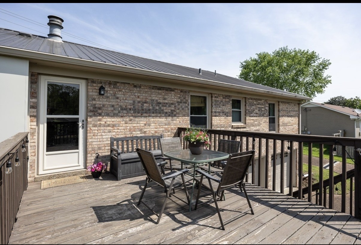 705 Baugh Road Nashville, TN 37221 - Photo 27 of 31 a view of a roof deck with chair and wooden floor