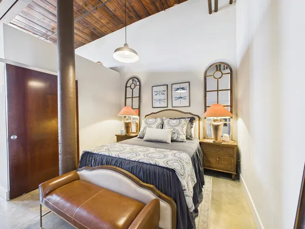 a bedroom with a bed and ceiling fan