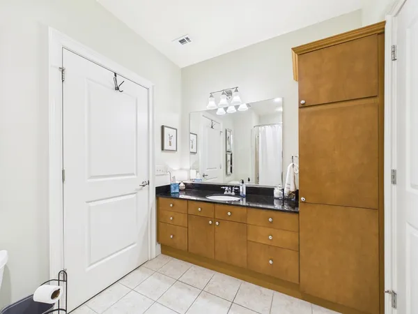 a bathroom with a double vanity sink mirror and shower