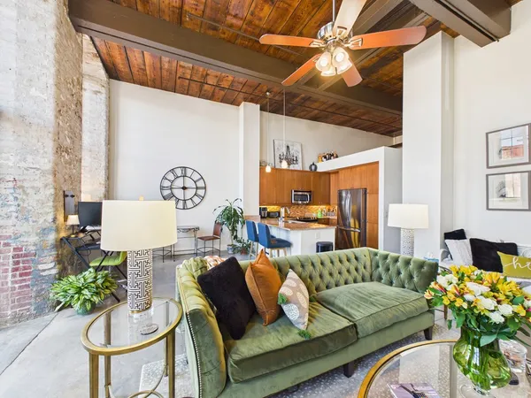 a living room with furniture and a chandelier