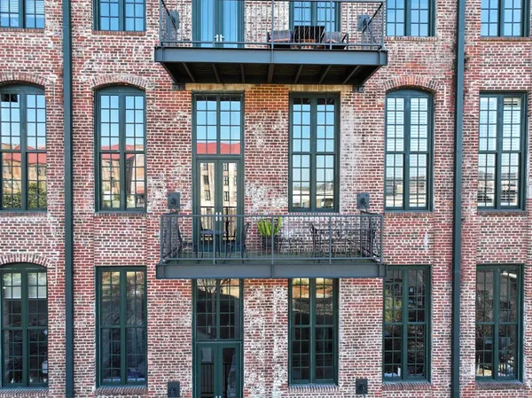 a front view of a brick building with many windows