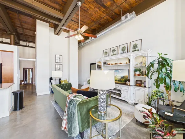 a living room with fireplace furniture and a wooden floor