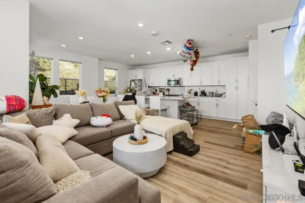 a living room with furniture and a chandelier