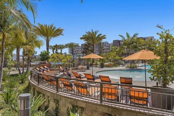 a view of a swimming pool with a patio and a yard