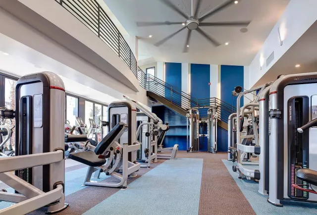 a view of a room with lots of gym equipment