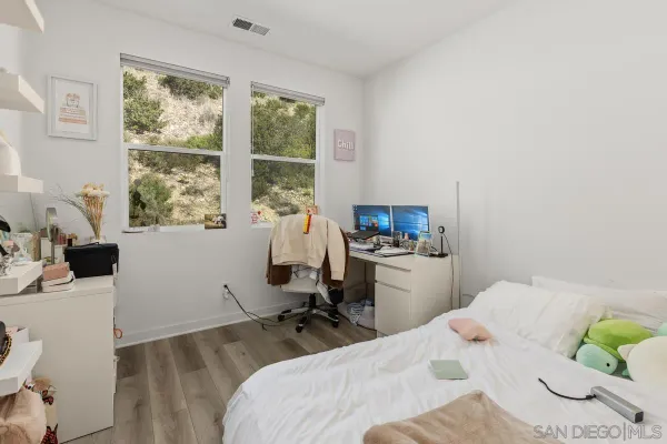 a bedroom with a bed and a desk