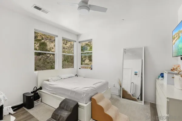 a bath room with a bed and a large window