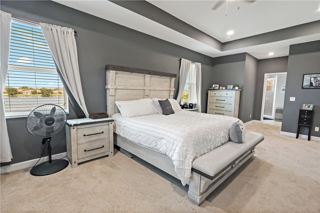 1782 Berkshire Circle Southwest Vero Beach, FL 32968 - Photo 16 of 35 a bedroom with a bed and a chandelier